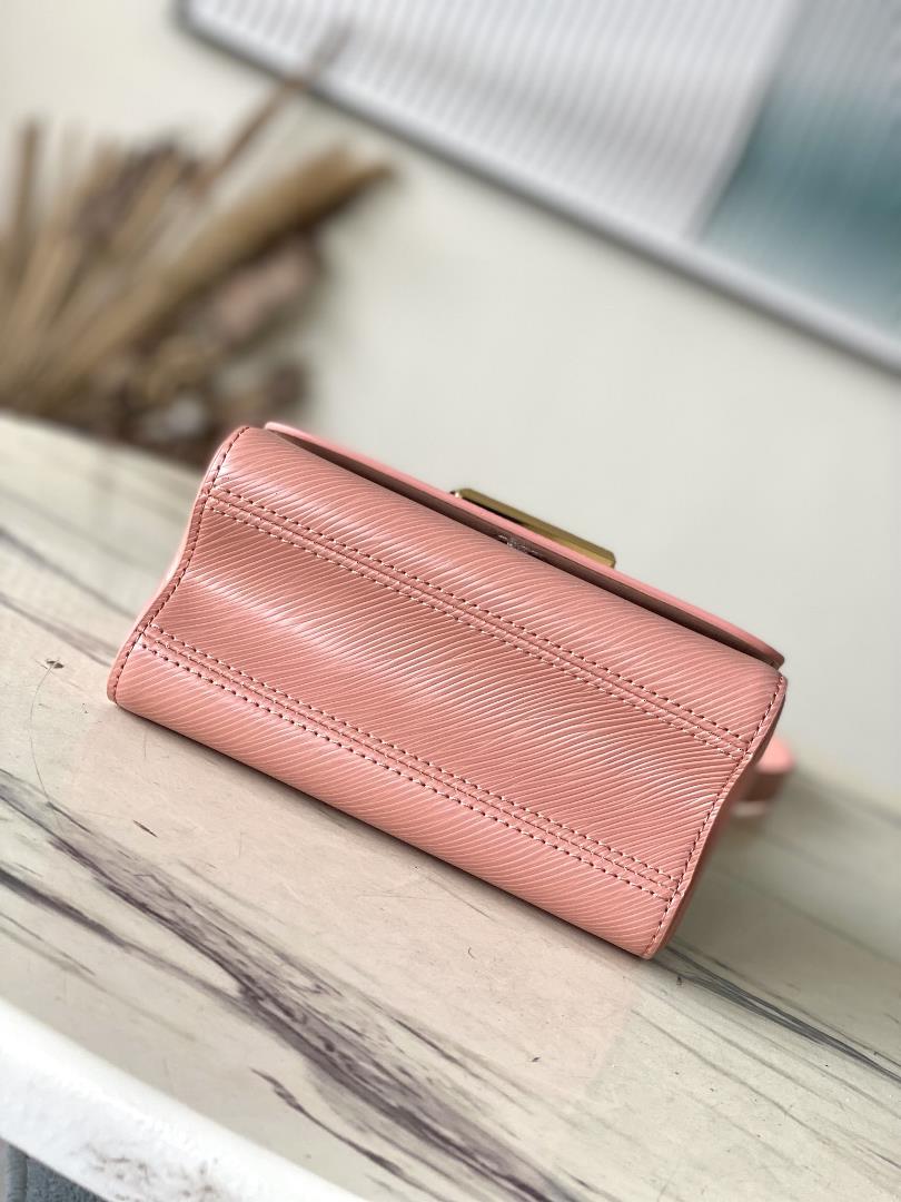 M23074 Peach PowderThis Twist small handbag incorporates the brands iconic Monogram flowe