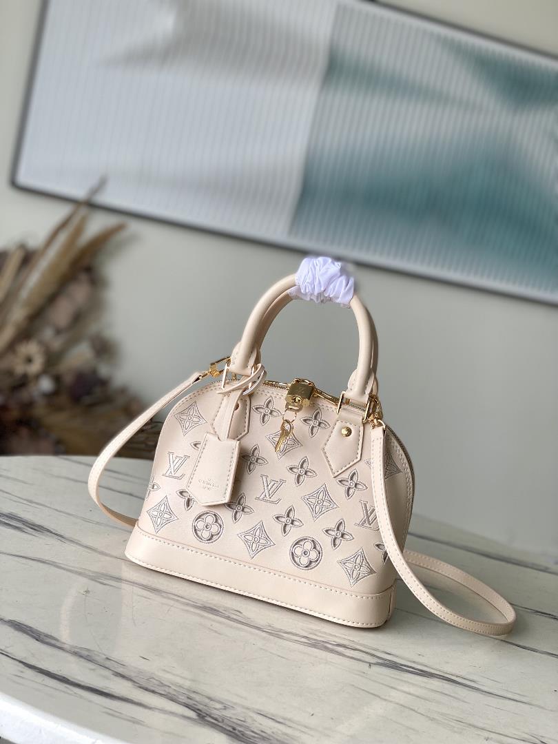 M22878 off white 91606 perforated off whiteThis Alma BB handbag originates from the LV Broderie Angl