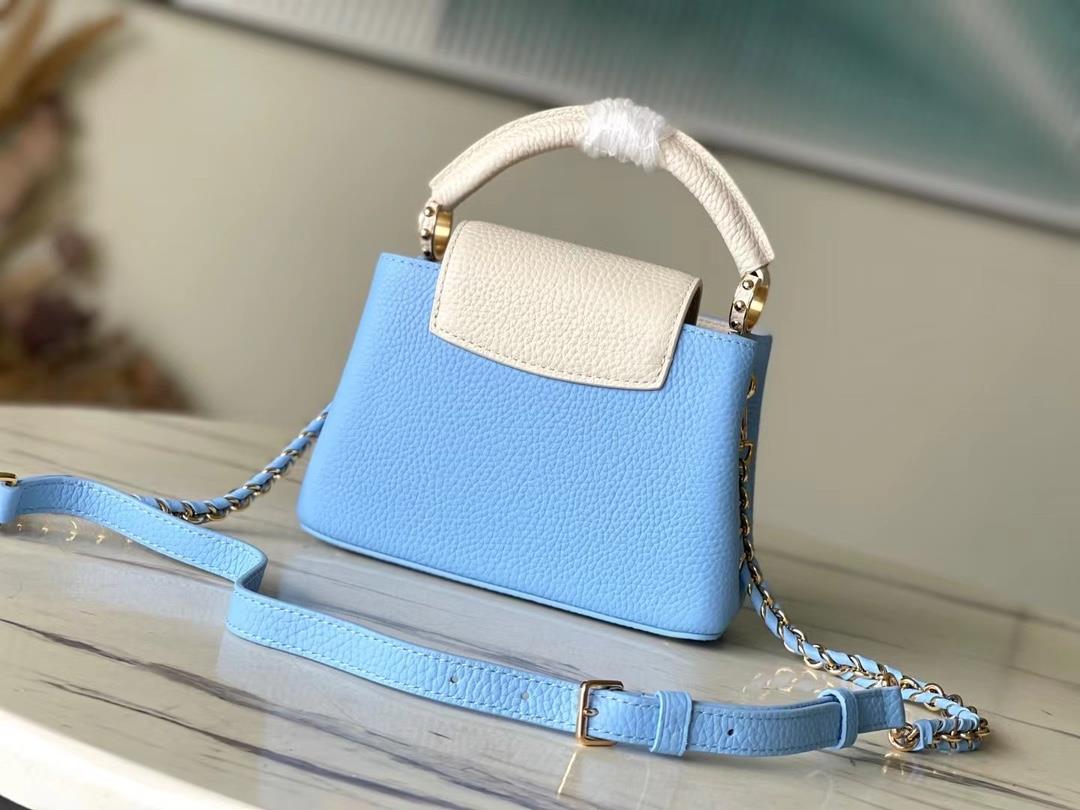 M21887 blue mini Taurilon leather version of the Capuchines mini handbag presents a soft a