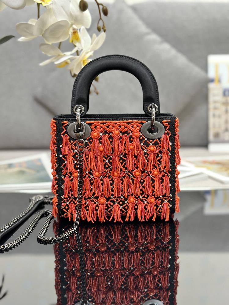 The Dior M0505 Lady Dior bag adorned with vibrant and intricately embroidered coral red b