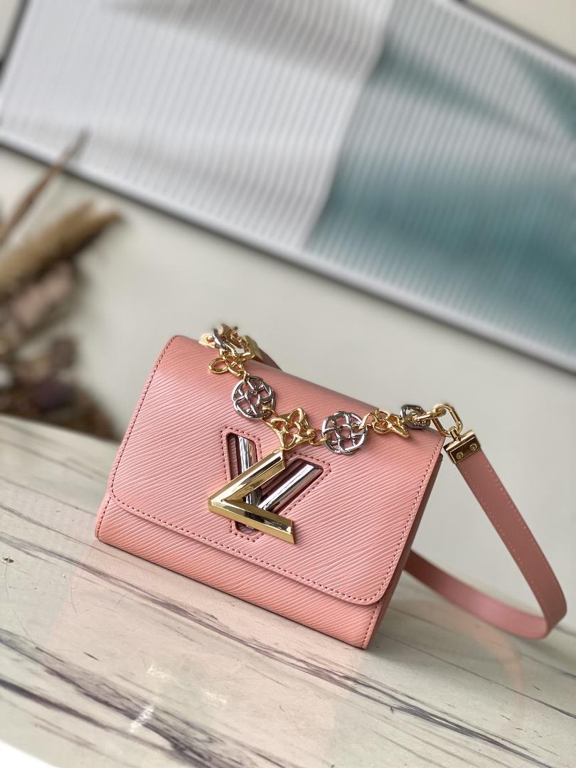 M23074 Peach PowderThis Twist small handbag incorporates the brands iconic Monogram flowers into th