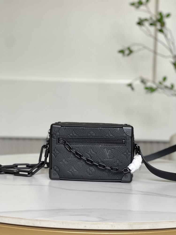 The M82558 M55702 Mini Soft Trunk handbag is made of soft Taurillon leather resembling a miniature version of a traditional hard box The chain and l