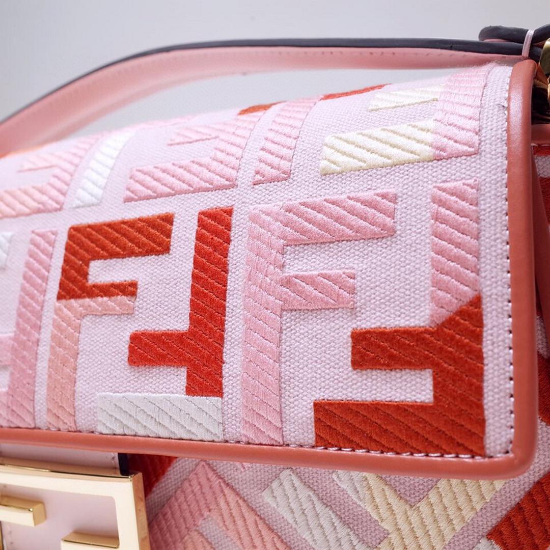 The FEND1 iconic Baguette handbag is made of canvas material and is adorned with red and pink 