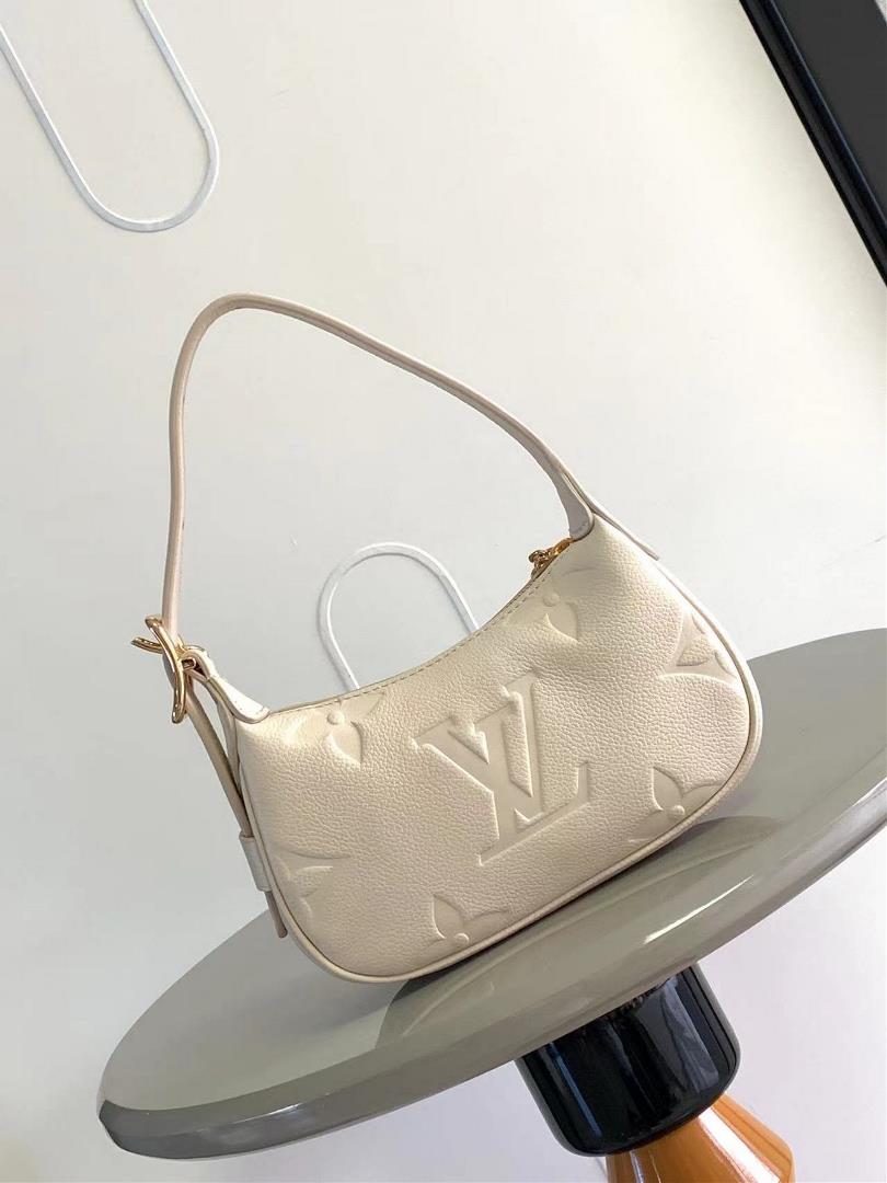 The M82391 M82519 Mini Moon handbag is made of soft Monogram Imprente embossed leather al